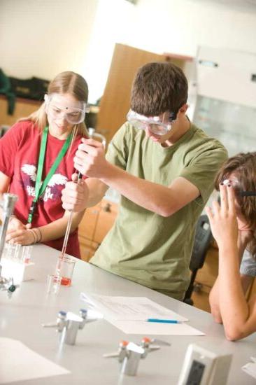 Student experiment in biology lab with two other students